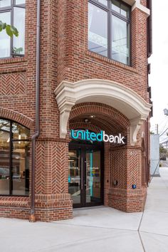 the front entrance to a bank with an arched doorway and sign above it that reads united bank