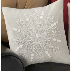 a white pillow sitting on top of a couch