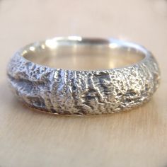 a silver ring sitting on top of a wooden table