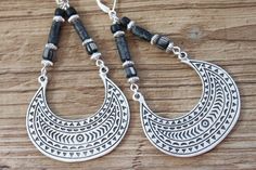 These boho earrings are made with ethnic silver plated charm, black hava glass beads, Czech glass tube and matte black seeds. They're perfect for adding a touch of bohemian style to your look. They hang from sterling silver lever backs. Whether you're dressing up for a night out or just want some fun new jewelry, these earrings will be a great addition. Plus, they're large and long enough to make a statement. Leverbacks keep your earrings on securely by creating a closed loop. Color : Black Czec Black Bohemian Hoop Earrings For Festivals, Black Bohemian Sterling Silver Earrings, Black Bohemian Pierced Jewelry, Bohemian Black Hoop Earrings With Dangling Beads, Bohemian Black Metal Hoop Earrings, Bohemian Black Nickel-free Hoop Earrings, Bohemian Nickel-free Black Hoop Earrings, Silver Eye, Big Earrings