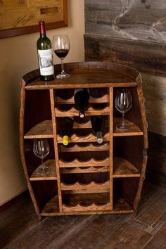 a wooden wine rack with several bottles and glasses