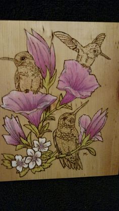 a wooden box with flowers and birds painted on it