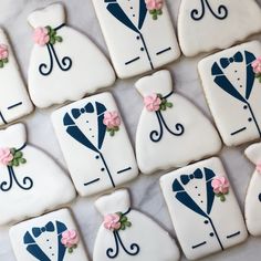 decorated cookies are arranged in the shape of groom and bride's tuxedos