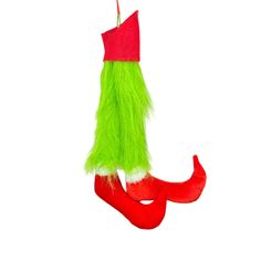 an ornament hanging from a red and green christmas stocking on a white background