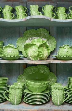 green cabbage dishes and cups on shelves in a store