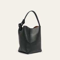 JW Anderson "Corner" bucket bag in grain calf leather  Shoulder strap with oversized chain-link accent, 8.5" drop Open top with magnetic closure  Interior, one slip pocket  Lining: Suede Approx. 12.2"H x 9.1"W x 7.1"D Made in Hungary Rectangular Textured Leather Bucket Bag For Work, Smooth Grain Top Handle Bucket Bag For Work, Luxury Smooth Grain Bucket Bag For Work, Textured Leather Shoulder Bucket Bag For Work, Formal Calf Leather Bucket Bag With Smooth Grain, Office Bucket Bag With Smooth Grain In Tote Style, Office Tote Bucket Bag With Smooth Grain, Calf Leather Bucket Shoulder Bag With Smooth Grain, Structured Leather Bucket Bag