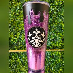 the starbucks cup is decorated with purple glitter