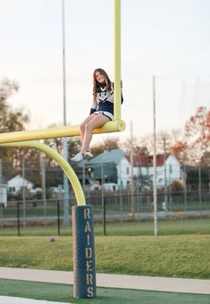 Cheerleader football senior photos at sunset Cheerleading Senior Pictures Ideas, Cheer Team Pictures Poses High Schools, Senior Photos Football Field, Cheer Solo Poses, Athletic Trainer Senior Pictures, Cheer Picture Poses Individual Football