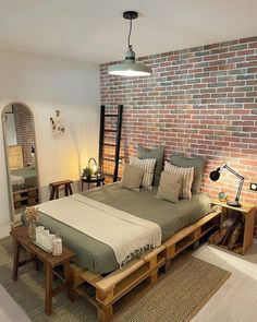 a bedroom with brick wall and wooden furniture in the corner, along with a bed made out of pallets