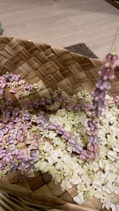 purple and white flowers in a woven basket