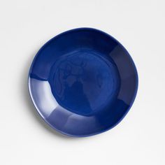 a blue plate on a white surface with an image of a dog in the center