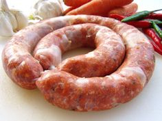 two sausages and some vegetables on a table