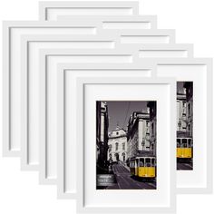 a set of six white frames with yellow trams on the street and buildings in the background