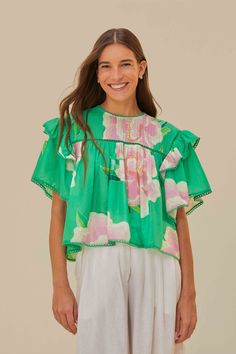 Embrace the vibrancy of the season with the Green Floral Vibing Blouse, a lively symphony of bright green hues and whimsical floral prints. This alluring piece features a round neckline complemented by fluttering ruffle sleeves and a delicate trim. The soft, flowing cut creates a playful yet refined silhouette that dances with each step. Perfect for infusing your wardrobe with a touch of tropical charm and effortless elegance. Composition 100% COTTONCare Instructions MACHINE WASH DELICATE CYCLE, DO NOT BLEACH, DO NOT TUMBLE DRY, LINE DRYING, IRON AT MEDIUM HEAT, DRY CLEAN WITH ANY SOLVENT EXCEPT TRICHLOROETHYLENESize and Fit Inches XXS XS S M L XL Bust 41 3/4 43 3/4 45 3/4 47 3/4 50 3/4 54 Waist 39 3/4 40 3/4 41 3/4 42 3/4 44 1/4 45 3/4 Length 20 20 3/4 21 1/4 21 3/4 22 2/4 23 Hip N/A N/A Green Printed Tops For Vacation, Green Bohemian Blouse With Vibrant Print, Bohemian Green Blouse With Vibrant Print, Vibrant Green Floral Print Blouse, Green Printed Spring Tops, Green Short Sleeve Blouse For Beach, Green Bohemian Tops For Vacation, Casual Green Blouse With Floral Embroidery, Green Floral Print Blouse For The Beach