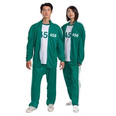 two people in matching green tracksuits with numbers on them