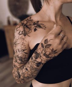 a woman with flowers on her arm and chest is shown in the instagramr