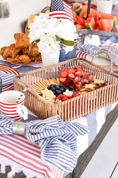 a picnic table with strawberries, watermelon, and other foods on it