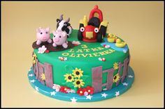 a birthday cake with farm animals on top