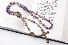 SAVE TODAY WHEN YOU SIGN UP FOR OUR NEWSLETTER Receive updates on upcoming sales, discounts and new products by signing up for newsletter using this link: http://bit.ly/TeamBelieversSave ♦DESCRIPTION♦ Beautiful heirloom quality and vintage-looking rosary is perfect gift for a women or girl celebrating one of the sacraments or special day. This rosary is made of delicate 8mm cape amethyst beads and moonstone gemstone beads with bronze metal findings. This rosary has a heavy weight with beautiful Bohemian Rosary With Natural Stones For Gifts, Purple Rosary, Rosa Mystica, Metallic Wrapping Paper, Catholic Necklace, Our Lady Of Lourdes, Lady Of Lourdes, Catholic Rosary, Rosary Catholic