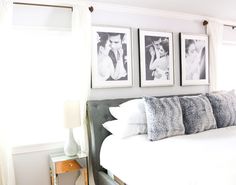 a bedroom with pictures hanging on the wall