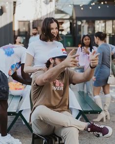 a man sitting on top of a chair next to a woman