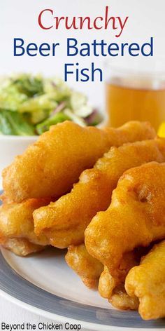 the cover of crunchy beer battered fish on a plate next to a glass of beer