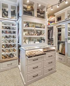 a walk in closet filled with lots of shoes and handbags on top of drawers