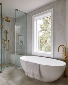 a white bath tub sitting next to a window