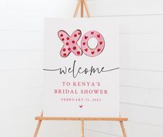 a sign that says welcome to kenya's bridal shower is displayed in front of a white wall