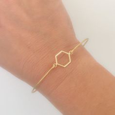 Geometric Jewelry - Hexagon Bracelet - Minimalist Jewelry - A gold tone hexagon charm will be transformed into a minimalist geometric bracelet with a brass band. I can also make this geometric minimalist bracelet with a 14k gold filled bangle band. If you would like this option for your geometric bangle bracelet, select from options when ordering.Please specify SIZE in notes to seller during checkout for your geometric hexagon bracelet... Choose from one of my regular sizes below by measuring on Adjustable Geometric Gold Jewelry, Elegant Geometric Bracelets Gift, Elegant Geometric Bracelets For Gifts, Elegant Geometric Bracelets For Gift, Gold Geometric Bracelet For Gift, Minimalist Adjustable Geometric Jewelry, Minimalist Gold Hexagon Jewelry, Texas Bracelet, Hexagon Bracelet