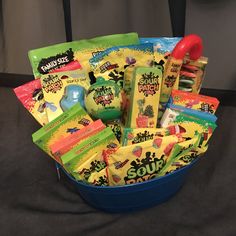 a blue bucket filled with candy and snacks