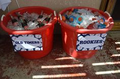 two red buckets filled with old timers soda bottles