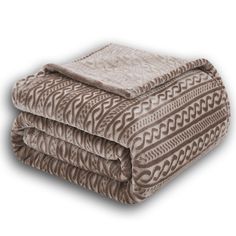 two blankets folded on top of each other in front of a white background with an intricate pattern