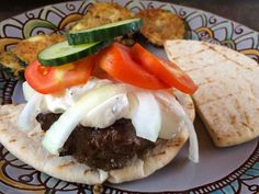 a plate with some tacos and other food items on it, including pita bread