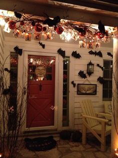 the front door is decorated for halloween with bats and pumpkins hanging from the ceiling