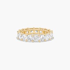 This timeless eternity ring features the boldness and intense sparkle of cushion cut diamonds. A classic, tailored shared prongs setting allows the maximum amount of the diamonds surface to show. *Number of diamonds and carat total weight will vary depending on ring size. Yellow Sapphire Rings, Diamond Eternity Ring, Rings Mens Wedding Bands, Carved Ring, Classic Wedding Rings, Platinum Wedding Rings, Pink Sapphire Ring, Princess Cut Rings, Round Cut Engagement Rings