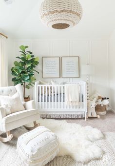 a baby's room with white furniture and decor