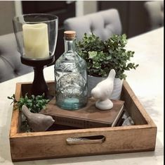 a tray with some bottles and candles on top of it next to a candle holder