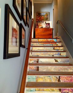 the stairs are decorated with pictures and paintings