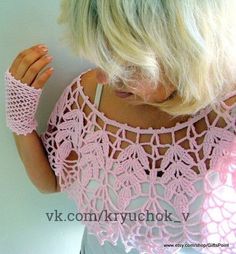 a woman with blonde hair wearing pink lacy crocheted arm warmers and looking down