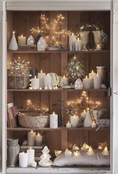 a book shelf filled with candles and other items