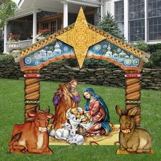 an outdoor nativity scene in front of a house