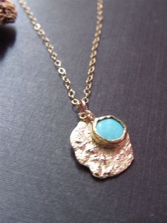 Necklace details: * The necklace and the pendant made from 14 karats solid Yellow gold. * Chain length 17.7inch/ 45cm. * 1 Turquoise. * Pendant width: 0.55x0.63inch/ 14x16cm. In pictures 7-10, you can see more examples of turquoise necklaces. Unusual handmade design for a classic gold pendant with Turquoise. Chain available in all sizes, color gold, karat, and Matte or Shining finish. Each pendant is custom made unique and will have slight variations in shape. IF YOU WANT A CUSTOM necklace pleas Blue Hammered Jewelry As Gift, Blue Hammered Jewelry As A Gift, Blue Hammered Jewelry For Gift, Elegant Yellow Gold Turquoise Necklace Gift, Gold Turquoise Pendant Necklace With Gemstone, Gold Turquoise Necklace With Round Pendant, Gold Turquoise Gemstone Necklace In Dainty Style, Handmade Dainty Gold Turquoise Necklace, Dainty Handmade Gold Turquoise Necklace