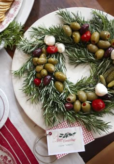 a plate topped with olives and cheese on top of a table