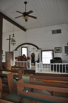 the inside of a church with wooden pews