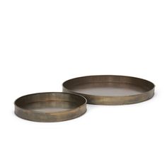 two round metal trays sitting next to each other