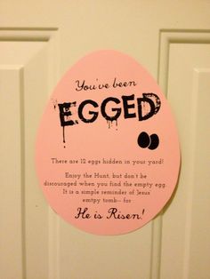 an egg is hanging on the door with a poem written in black and pink ink