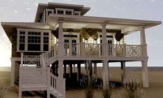 a large white house sitting on top of a sandy beach next to the ocean at sunset