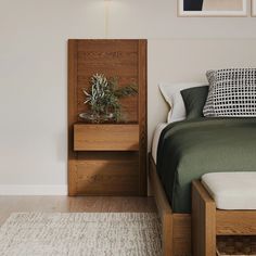 a bed room with a neatly made bed and a night stand next to the bed