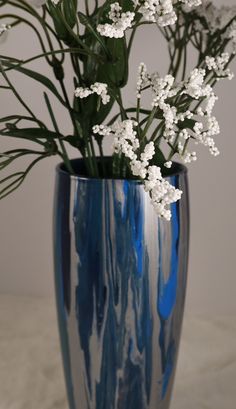 a blue vase with white flowers in it